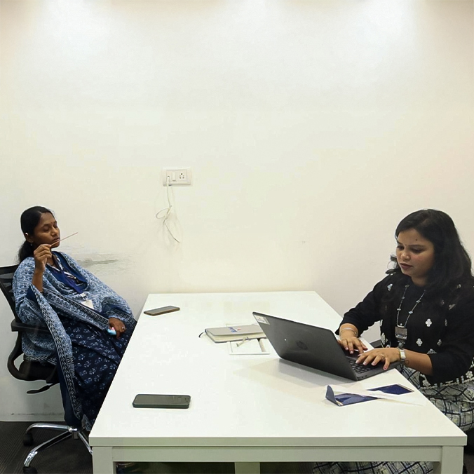 Two colleagues collaborating at their workstation at Pittie Group