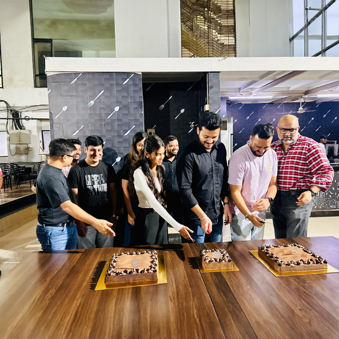 Colleagues celebrating with cake-cutting at Pittie Group